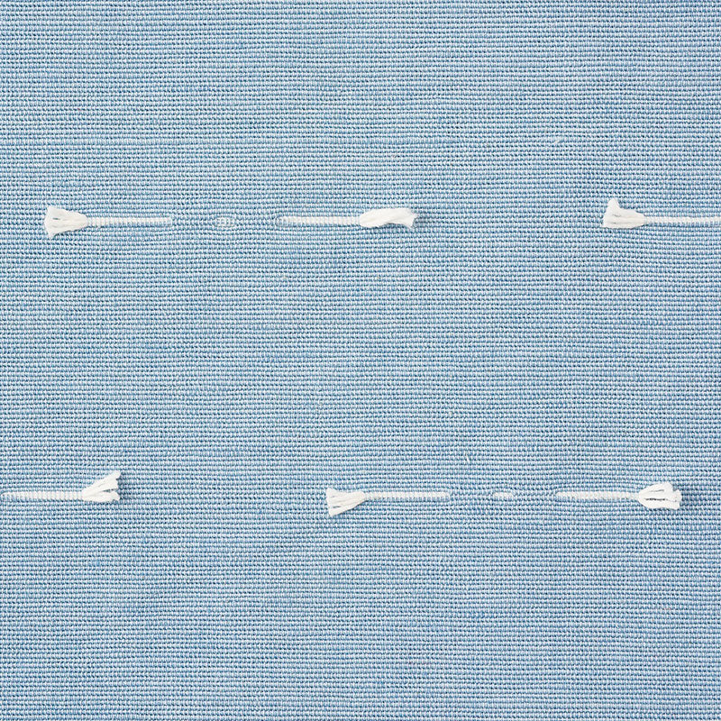 Light blue woven fabric with white running stitches across, showing textile texture and casual seam detail.