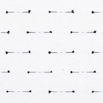 White fabric swatch with repeating small black dash stitches & rounded end dots; minimalist textile pattern.