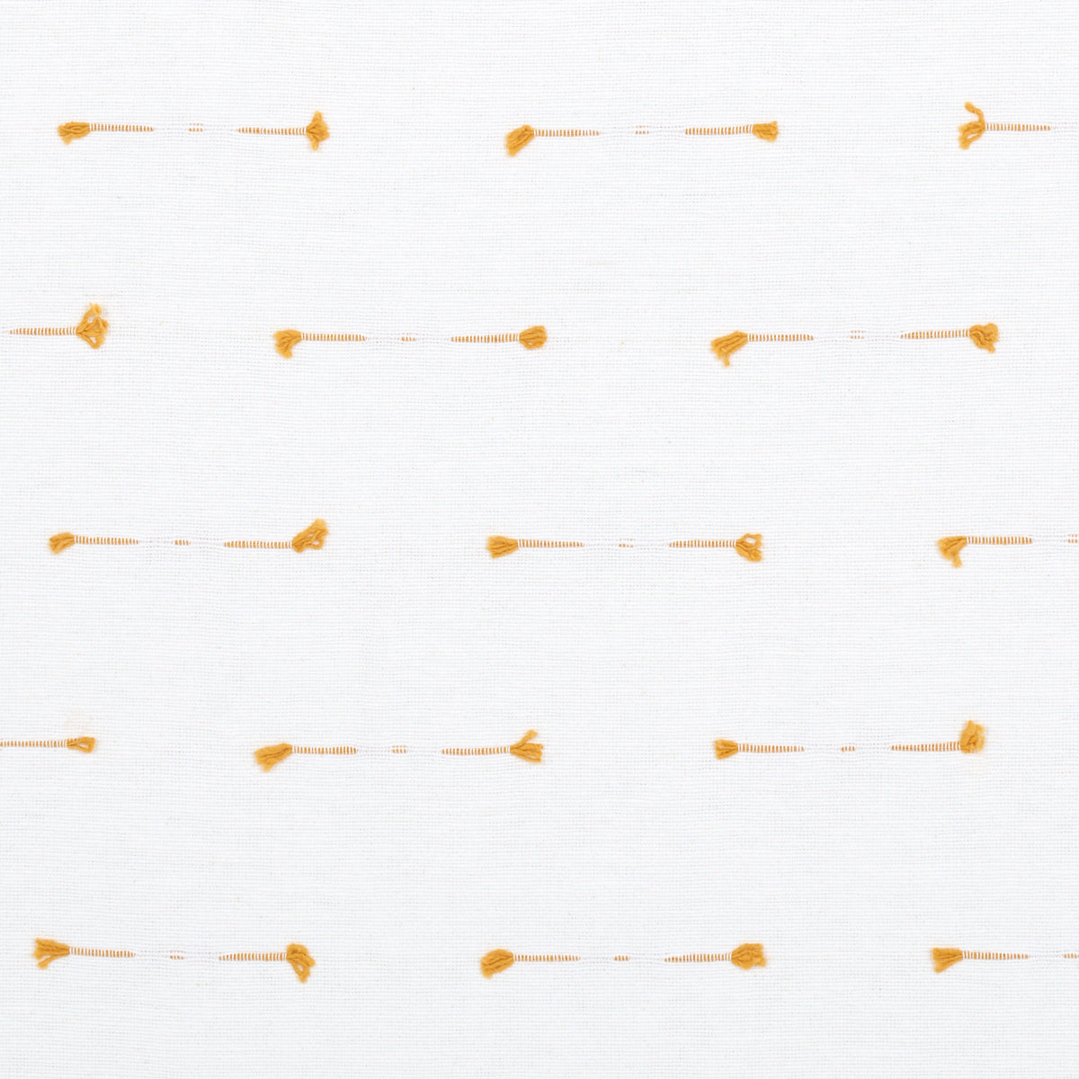White fabric with tiny orange stitched dash lines and rounded end dots in a subtle grid.
