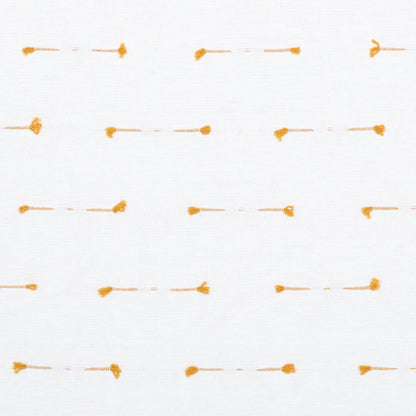 White fabric with tiny orange stitched dash lines and rounded end dots in a subtle grid.