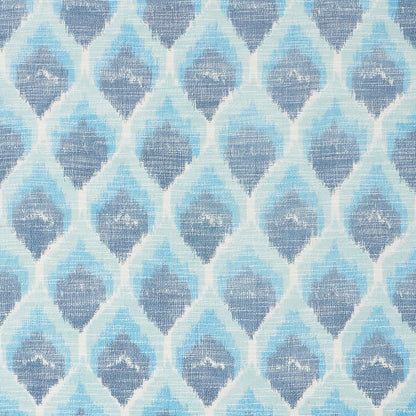 Blue ikat-inspired geometric textile with repeating teardrop/diamond shapes in light to dark blues.