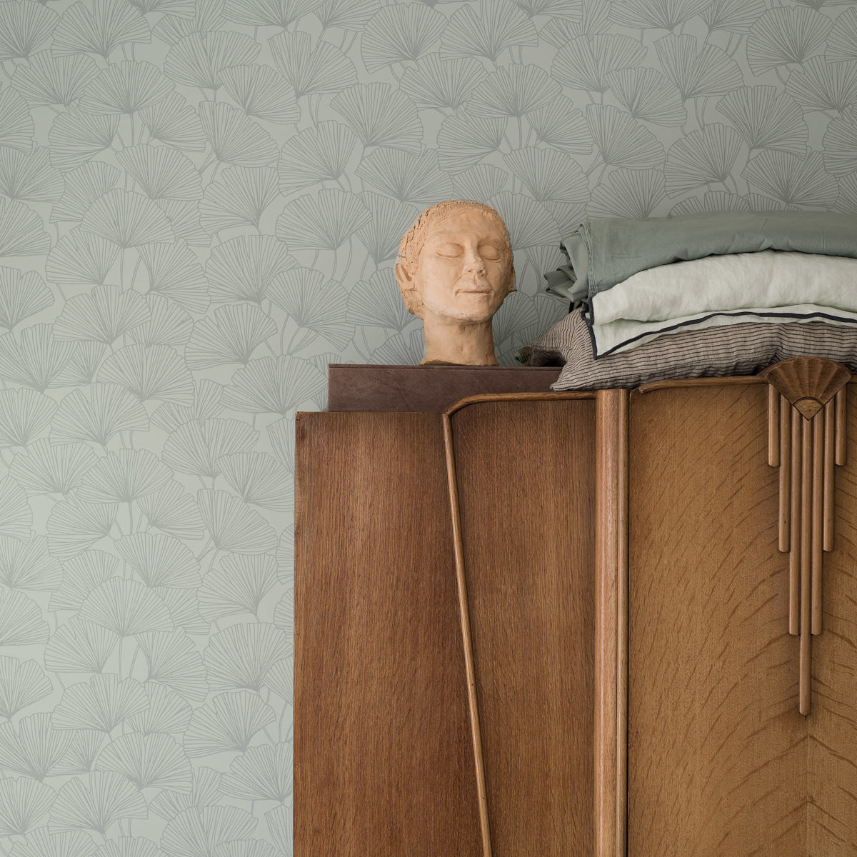 Wallpaper with a mineral-toned ginkgo leaf pattern.