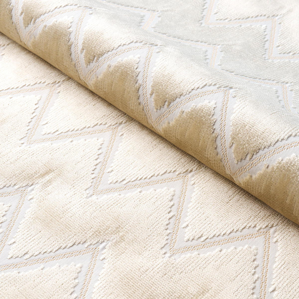 Beige and ivory chevron rug with plush texture and raised geometric pattern.