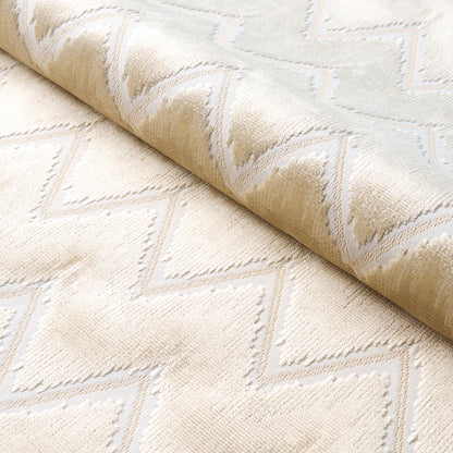Beige and ivory chevron rug with plush texture and raised geometric pattern.