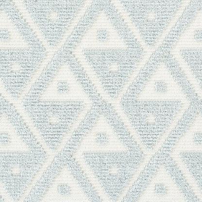 Soft blue and ivory geometric rug with diamond shapes and a woven textured surface.