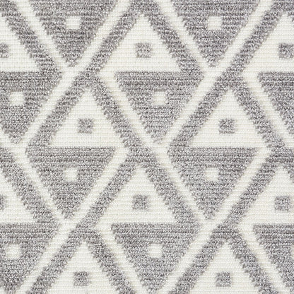 Gray and white geometric diamond textile rug with interlocking triangles and tiny square accents.