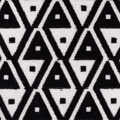 Black and white triangle tessellation on velvet; bold geometric pattern with tiny square accents.