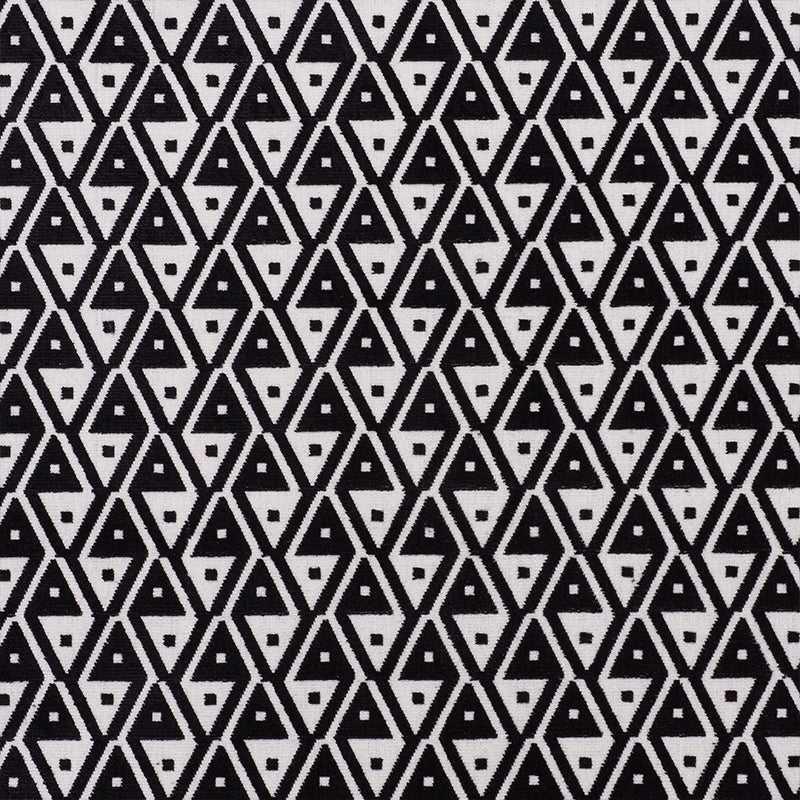 Black and white geometric fabric with interlocking diamond and triangle pattern, bold graphic textile print.