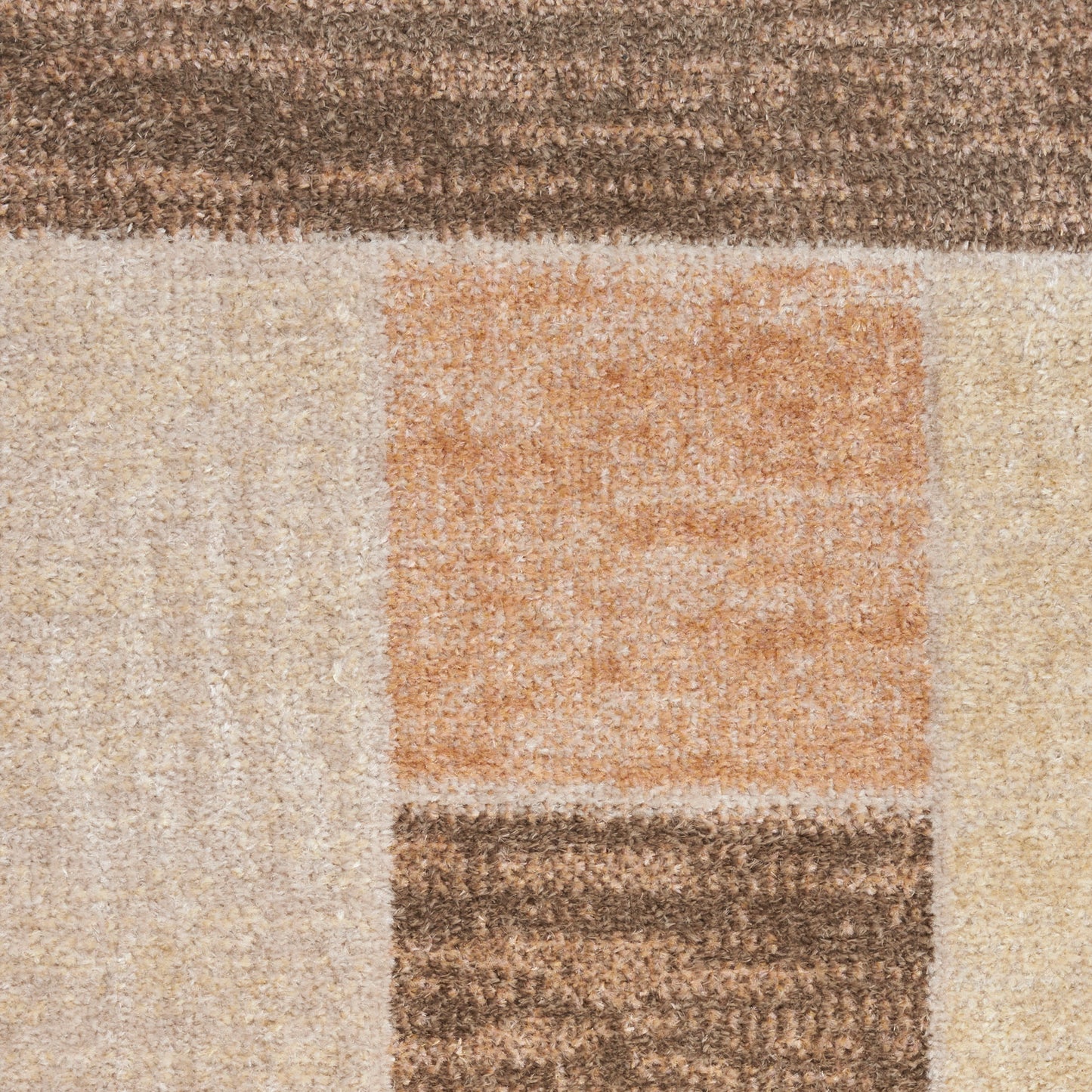 Geometric area rug with beige, cream, tan blocks and an orange square; textured, modern style.