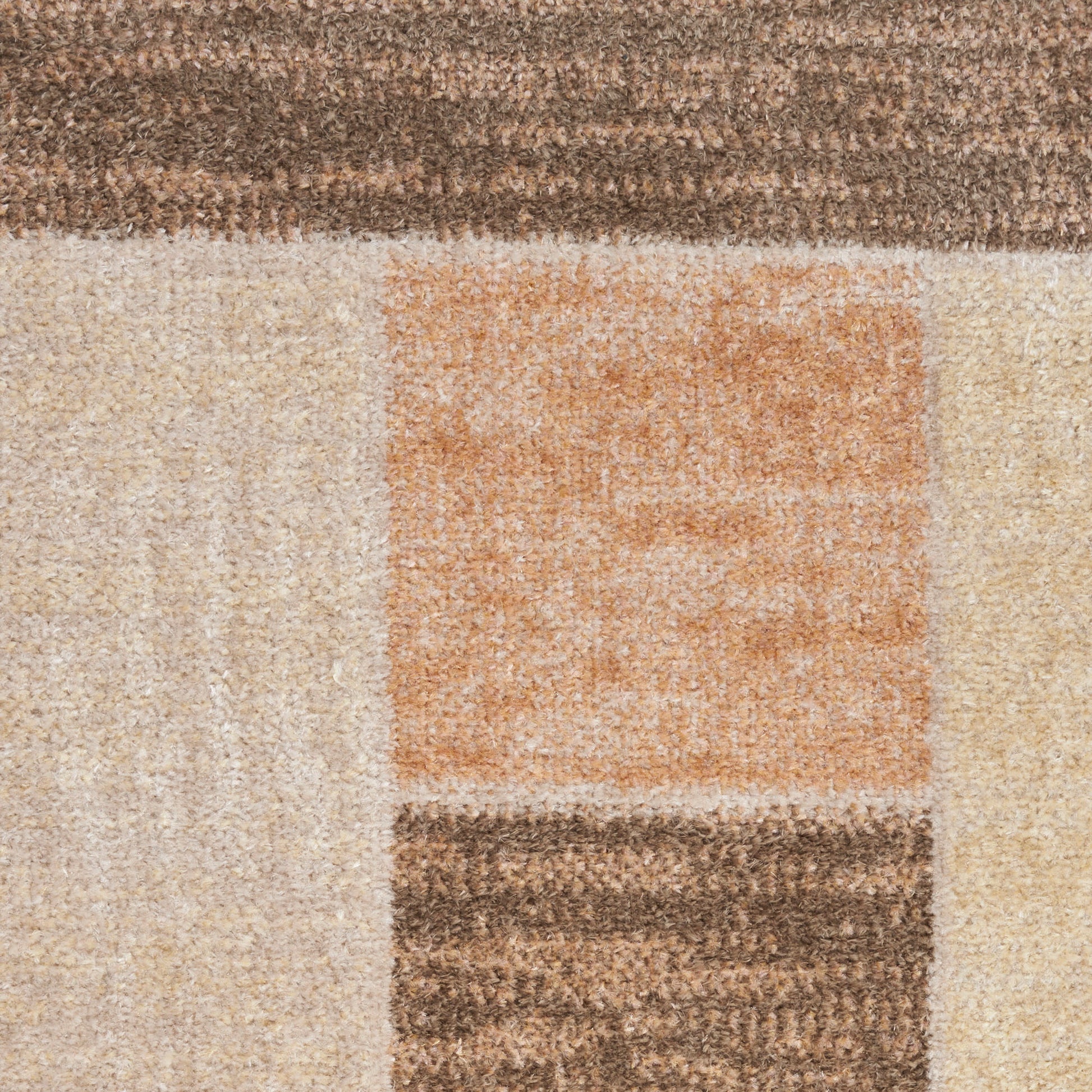 Geometric area rug with beige, cream, tan blocks and an orange square; textured, modern style.