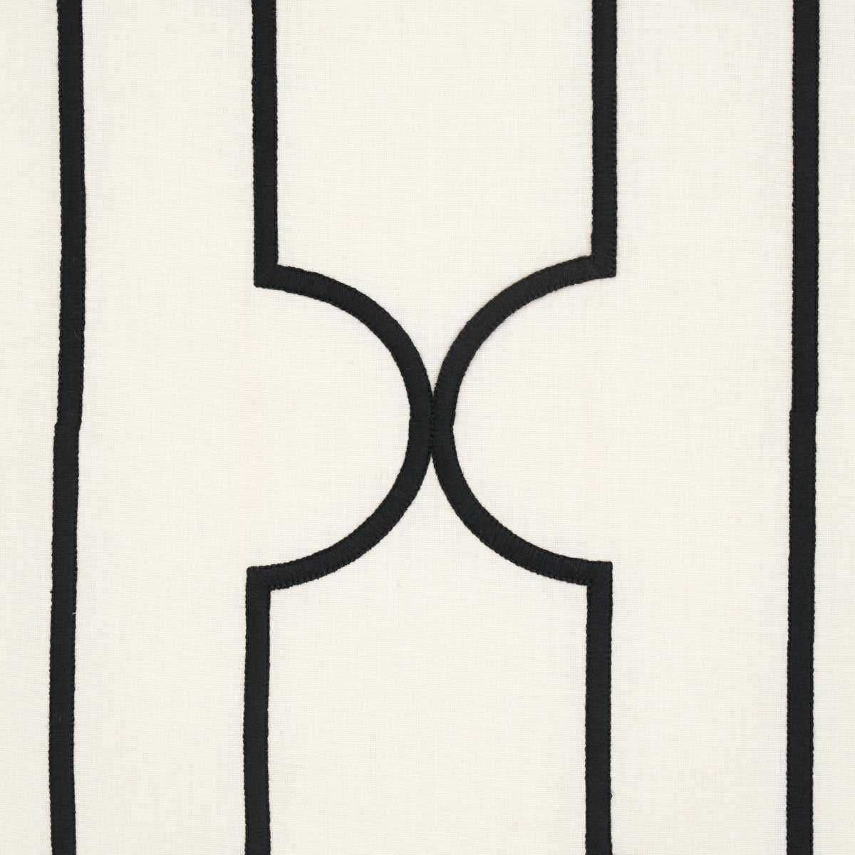 Cream textile with bold black vertical lines and mirrored curved arches forming a geometric motif.