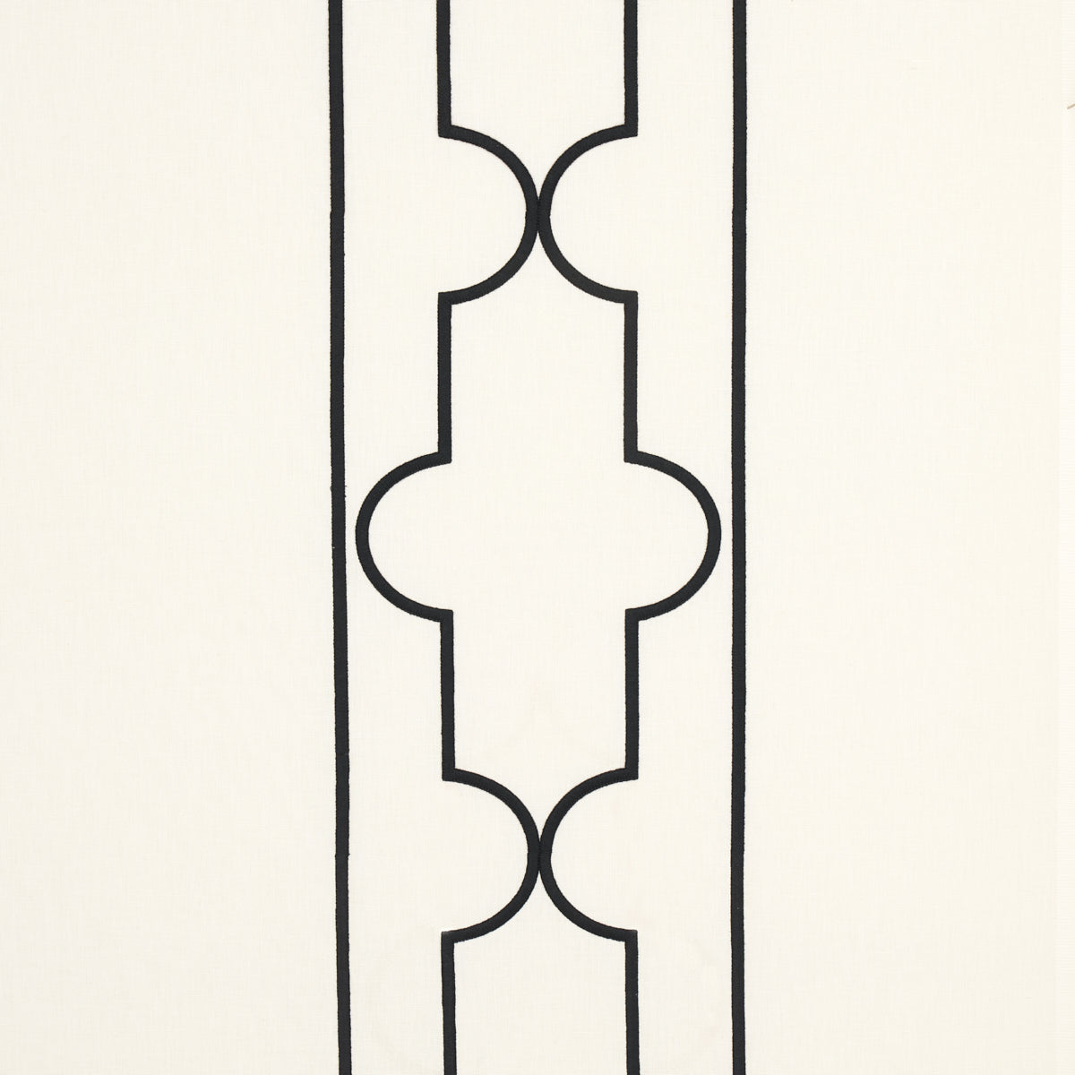 Cream background with a black lattice embroidery pattern of interlocking curved motifs.