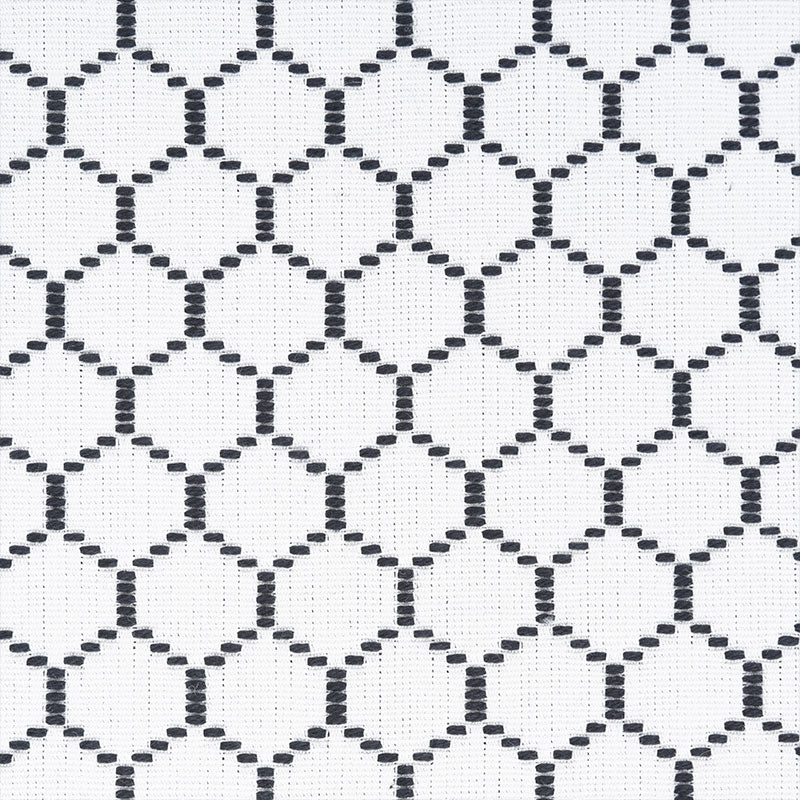 White fabric with a repeating black dotted circle lattice pattern; geometric, airy textile for fashion or home decor.