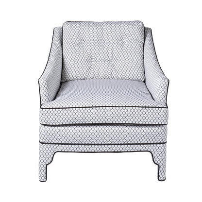 Diamond-patterned white fabric armchair with dark piping, cushioned seat and back, dark wooden legs
