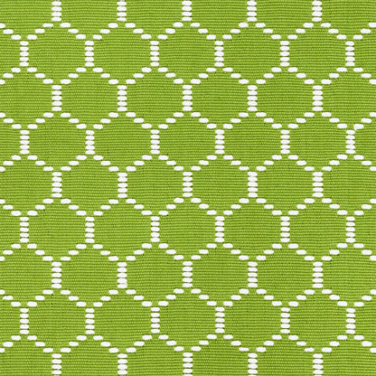 Lime green fabric with a white dotted circle lattice pattern; lightweight textile for clothing or home decor.