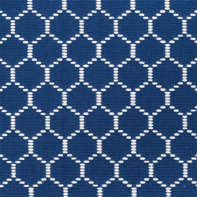 Navy blue fabric with a white dotted circle lattice pattern; a woven textile for upholstery or accessories.