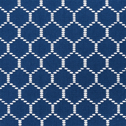 Navy blue fabric with a white dotted circle lattice pattern; a woven textile for upholstery or accessories.