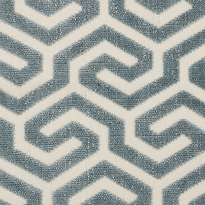 Blue-gray plush rug with interlocking geometric chevron pattern on white background.