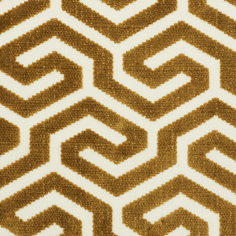 Gold metallic Greek-key geometric pattern on white textile; bold rug or upholstery fabric.
