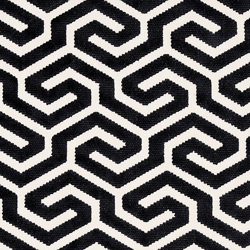 Gray rectangular panel centered on a black-and-white geometric rug; modern minimalist decor accessory.