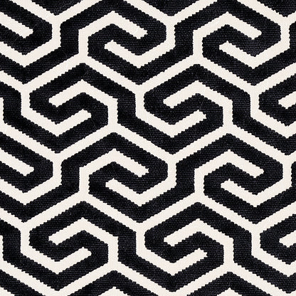 Gray rectangular panel centered on a black-and-white geometric rug; modern minimalist decor accessory.