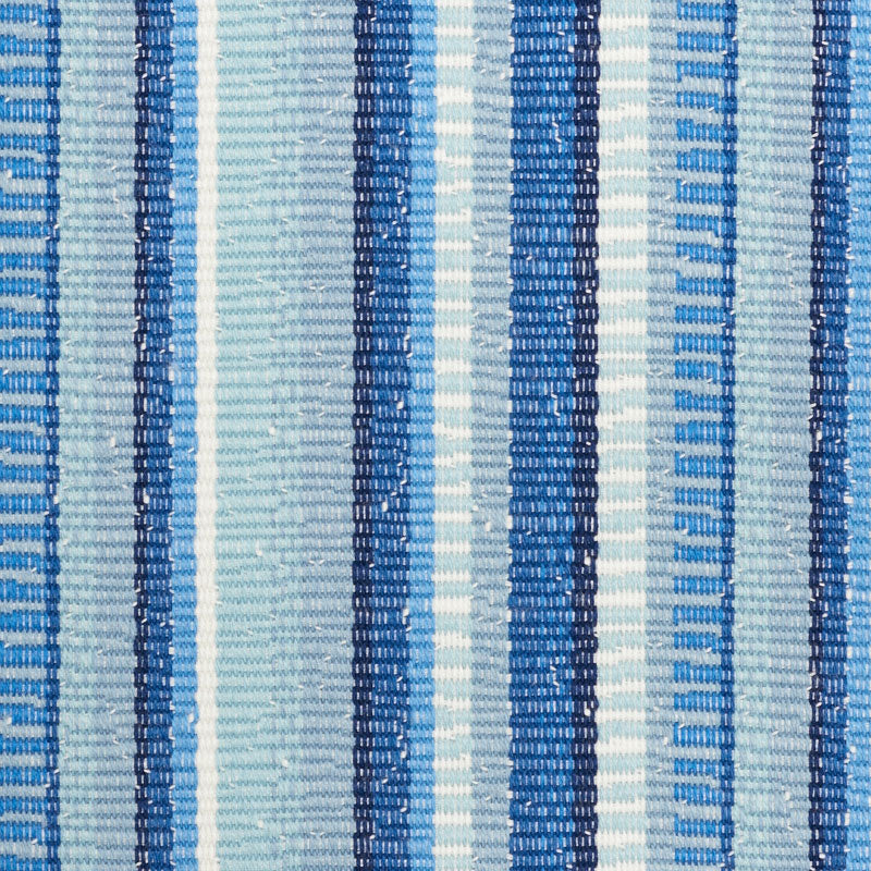 Close-up of blue and white striped woven fabric with alternating navy, royal blue, and light blue vertical stripes.