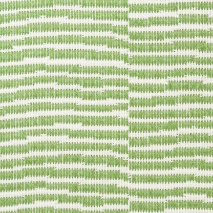 Green embroidered geometric trellis pattern on white fabric, two panels joined by a center seam.