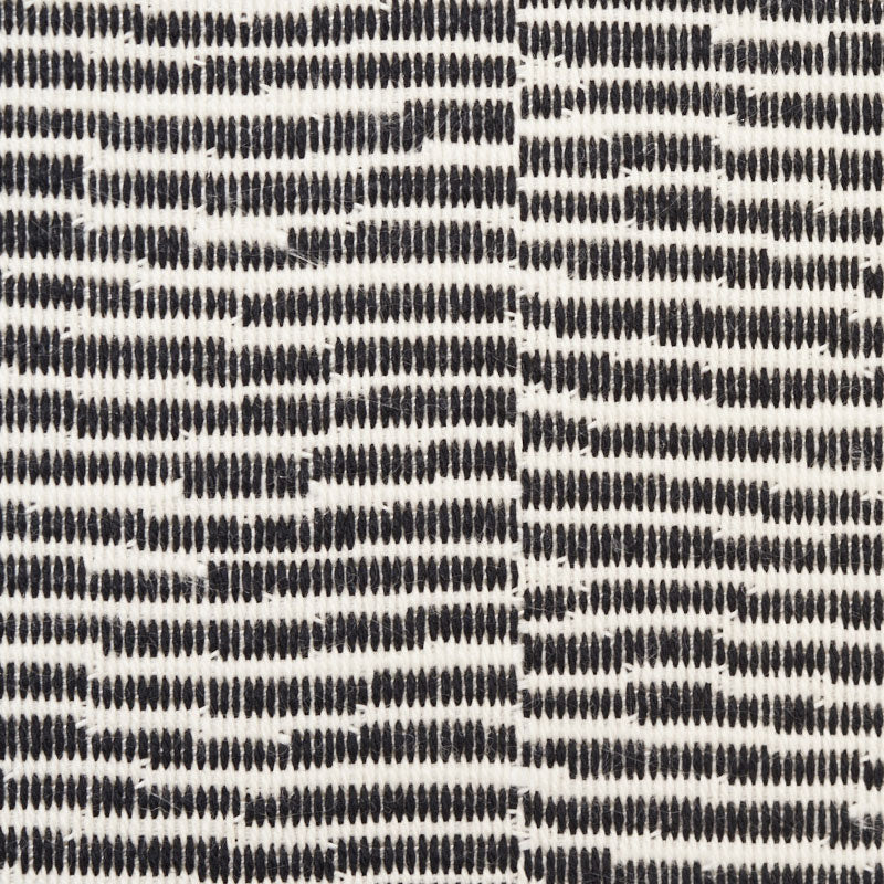 Cream fabric with black zebra-striped dash pattern; woven texture, suitable for upholstery or throw.
