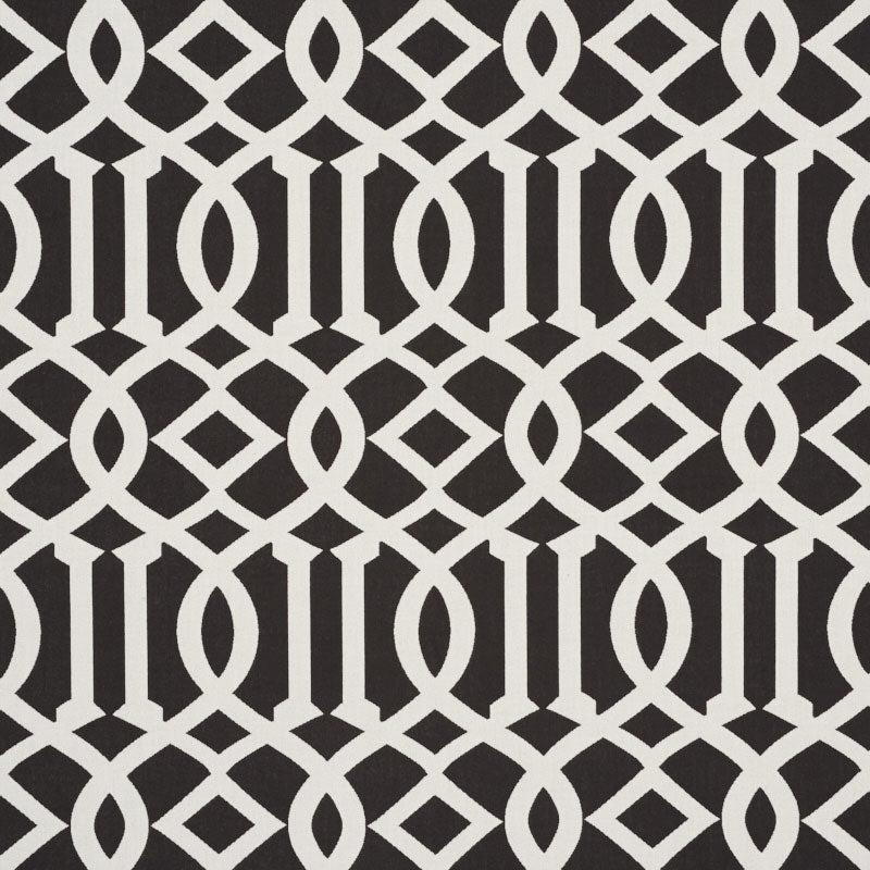 Cream interlocking lattice pattern on a dark brown background; geometric wallpaper/fabric design with diamonds and loops.