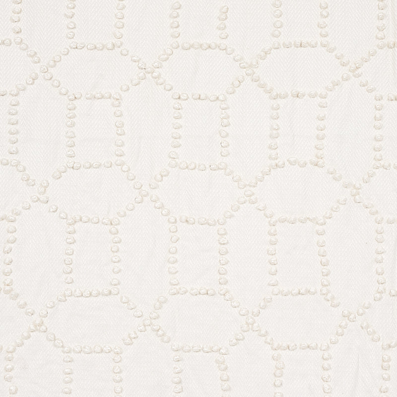 Cream fabric with raised dotted lattice pattern forming squares; soft textured material for upholstery or drapery.