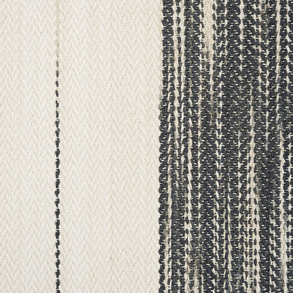Cream and navy woven rug with vertical panel contrast; left cream section, right navy striped section.