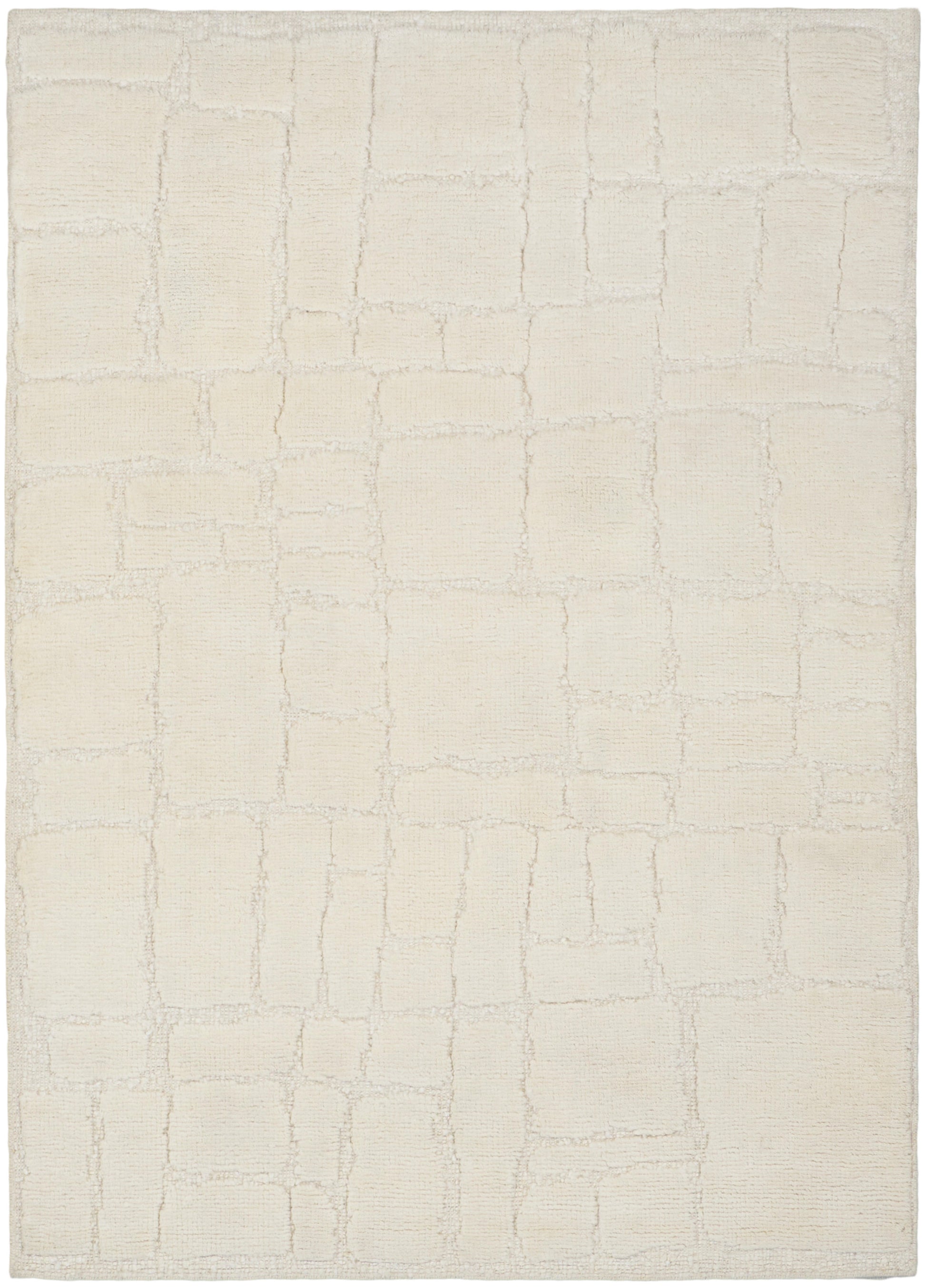 Cream area rug with a subtle rectangular tile pattern in soft beige, plush textured pile.