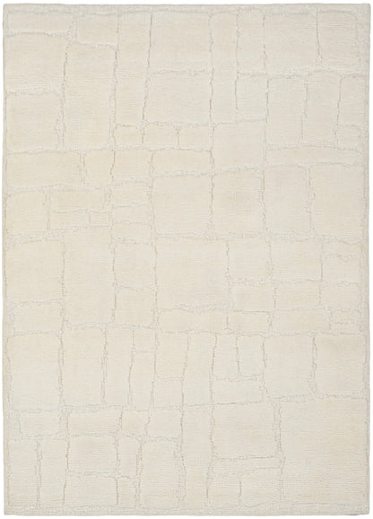 Cream area rug with a subtle rectangular tile pattern in soft beige, plush textured pile.