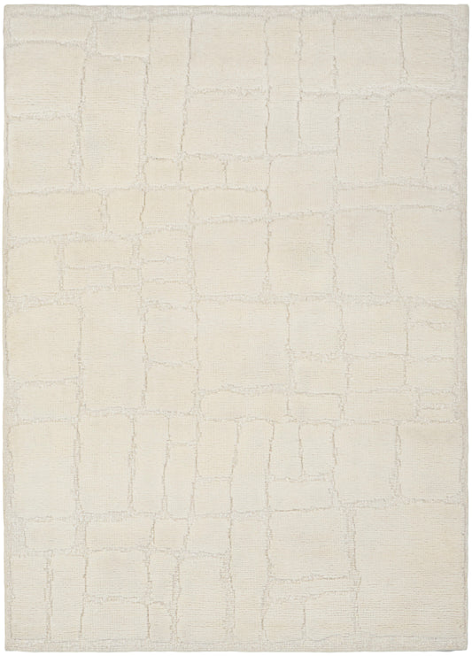 Cream area rug with a subtle rectangular tile pattern in soft beige, plush textured pile.