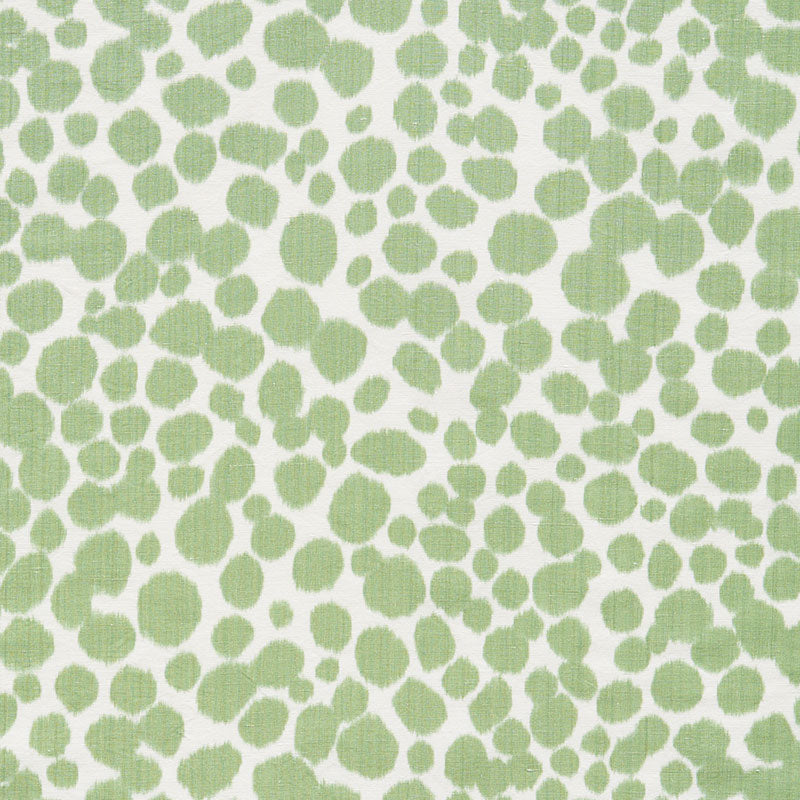 Lime green irregular dot pattern on white fabric; organic speckled print for textiles.