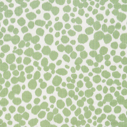 Lime green irregular dot pattern on white fabric; organic speckled print for textiles.