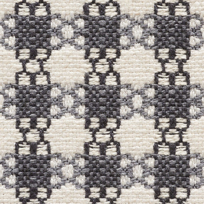 Woven textile with dark charcoal diamond lattice pattern on cream background; sturdy rug/fabric.