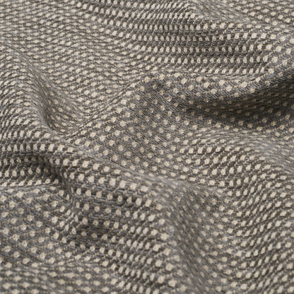 Grey tweed-like fabric with tiny beige dots, textured weave and soft drape.