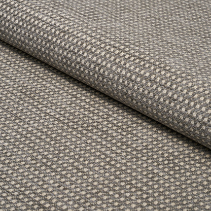 Rolled grey-taupe woven fabric with tiny raised dot pattern; versatile for upholstery, drapery or home decor.