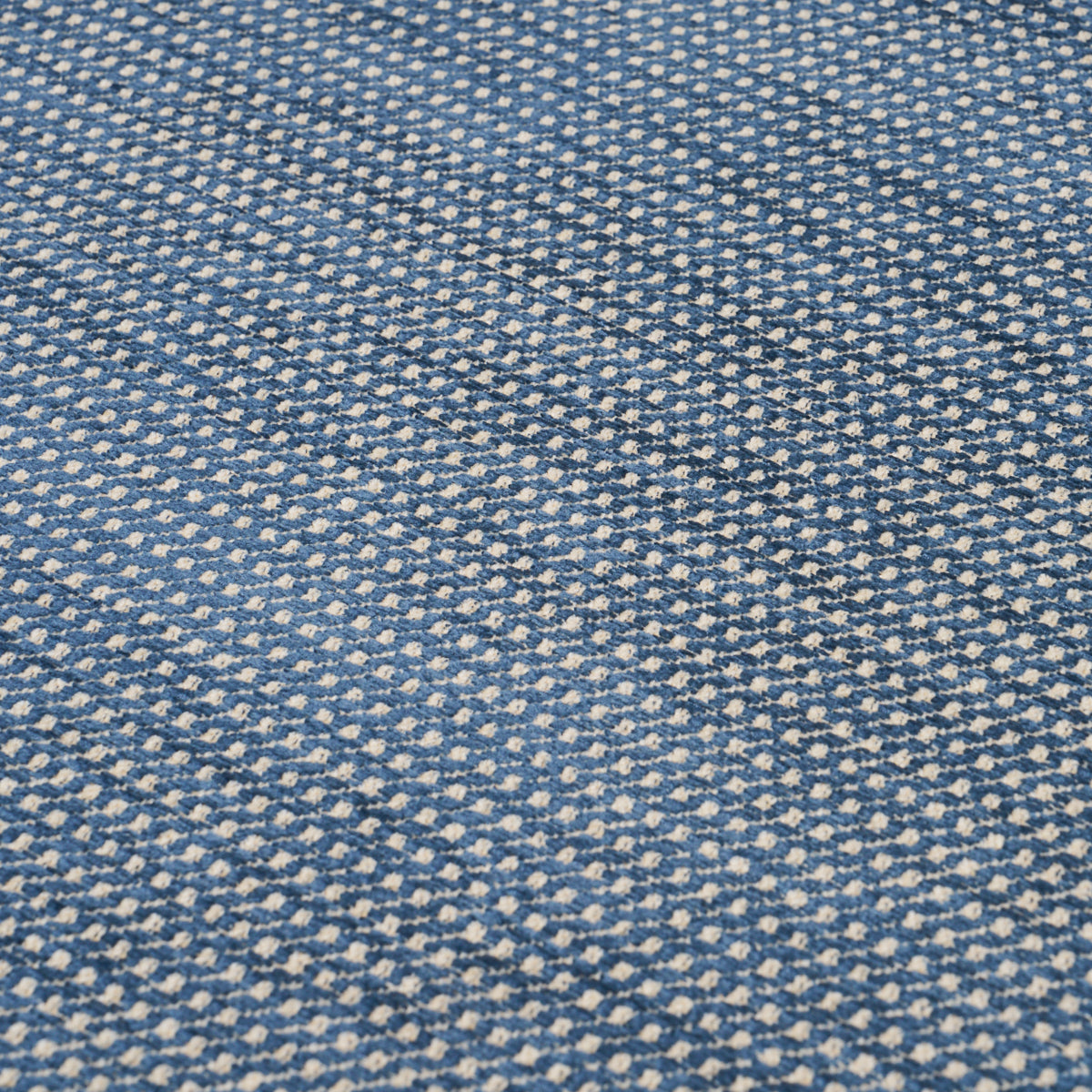Blue speckled woven fabric with white flecks; denim-like texture suitable for apparel or upholstery.