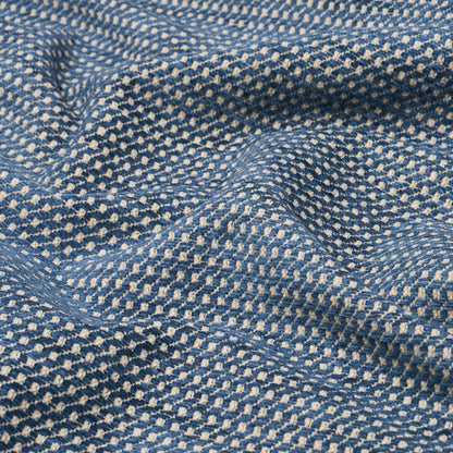 Blue & white dotted woven fabric with tiny white specks in a geometric pattern; soft, textured textile.