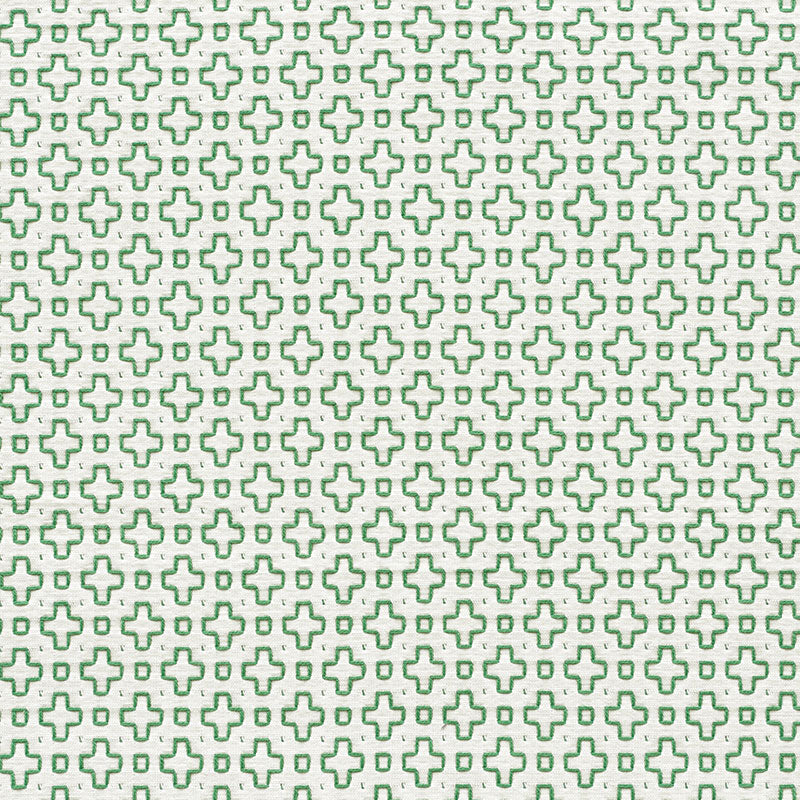 Repeating lime-green cross pattern on white fabric; geometric textile print for clothing or decor.