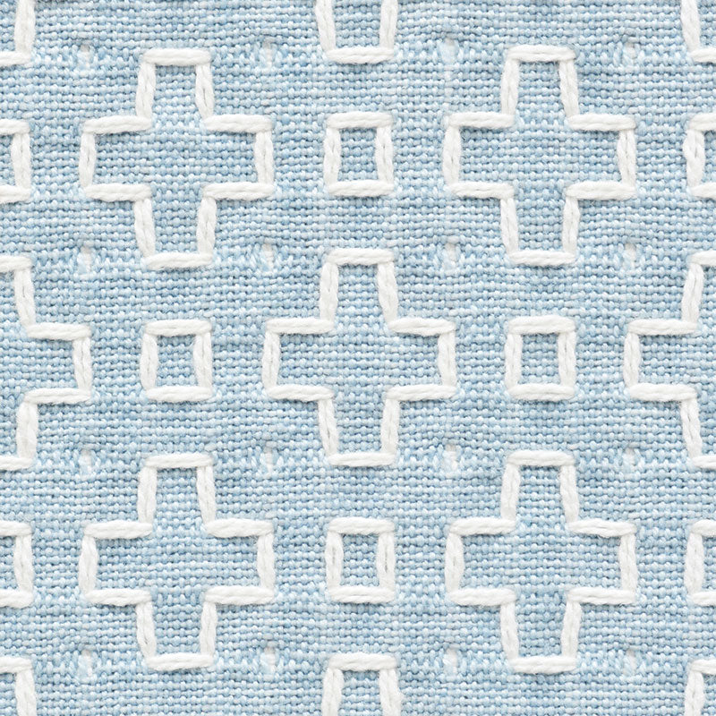 Light blue woven fabric with white embroidered plus-sign cross motifs in a repeating grid.