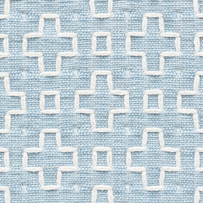 Light blue woven fabric with white embroidered plus-sign cross motifs in a repeating grid.