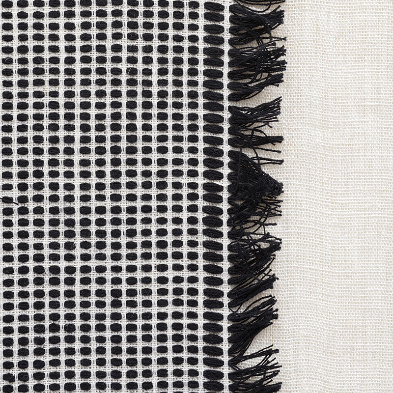 Black-and-white sheer window panels with a subtle grid pattern.
