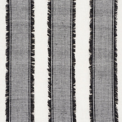 Black and white woven textile with three vertical striped columns and fringe along edges.