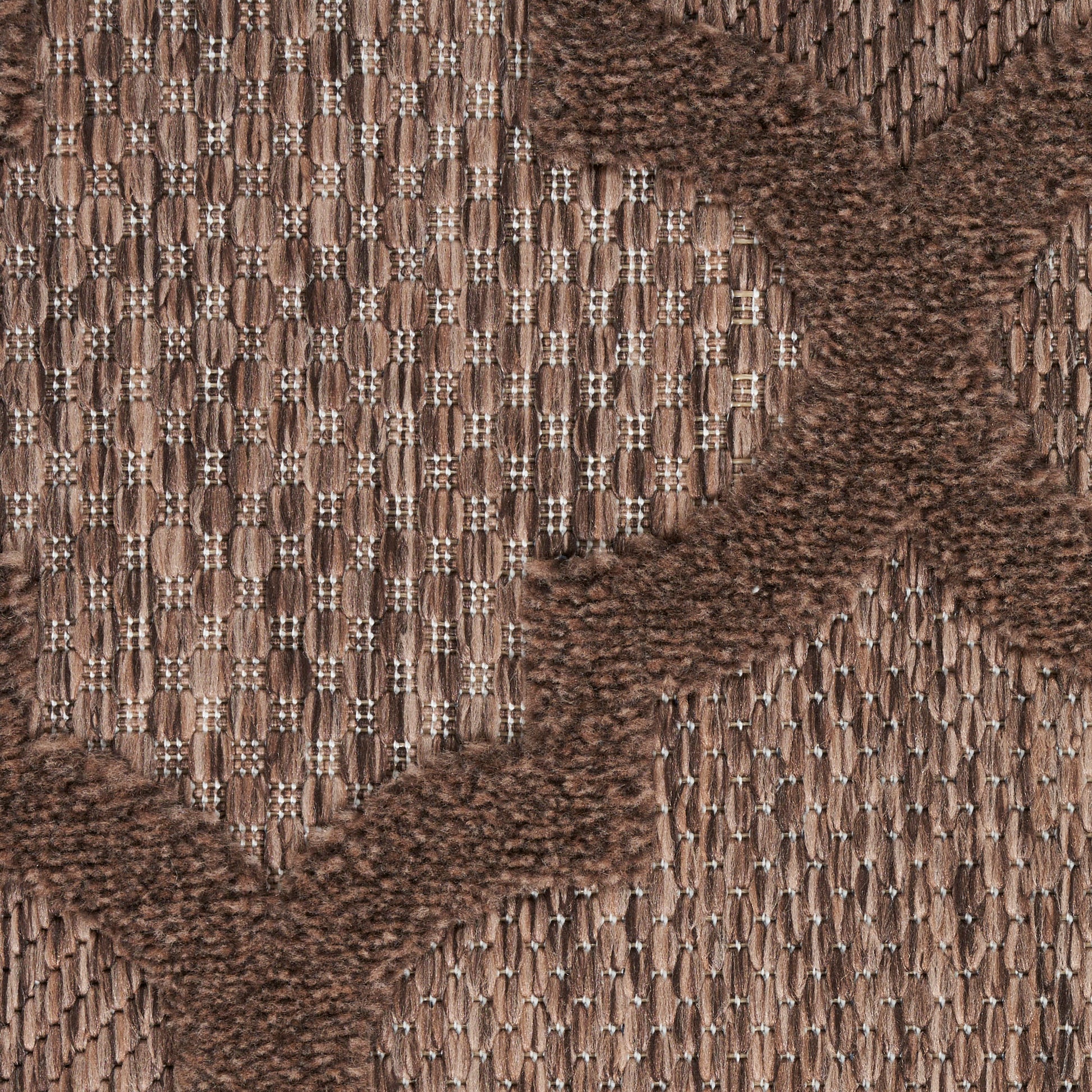 Brown jacquard woven fabric with tan and chocolate chevron pattern; textured upholstery textile for furniture or accessories.