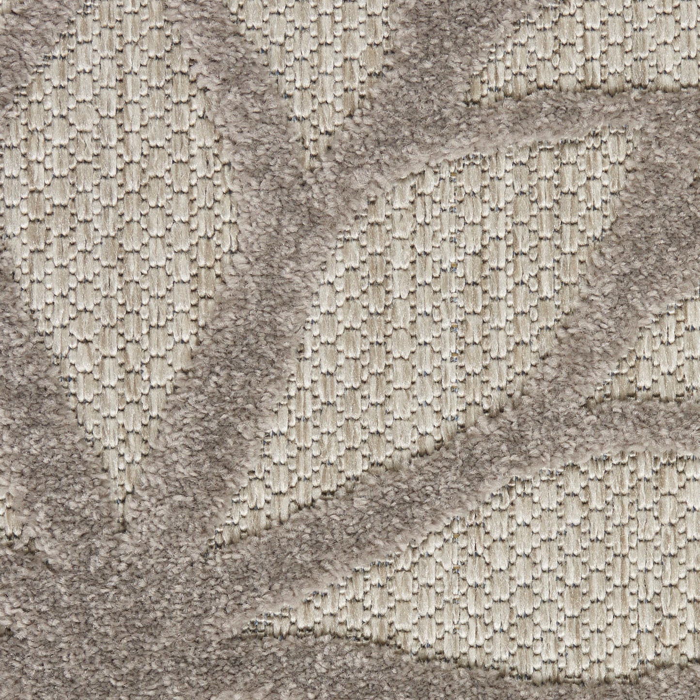 Beige textured rug with raised geometric pattern and soft looped pile.