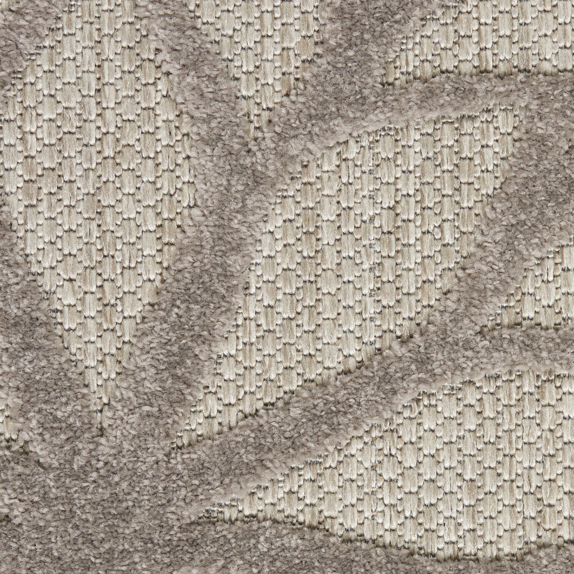 Beige textured rug with raised geometric pattern and soft looped pile.