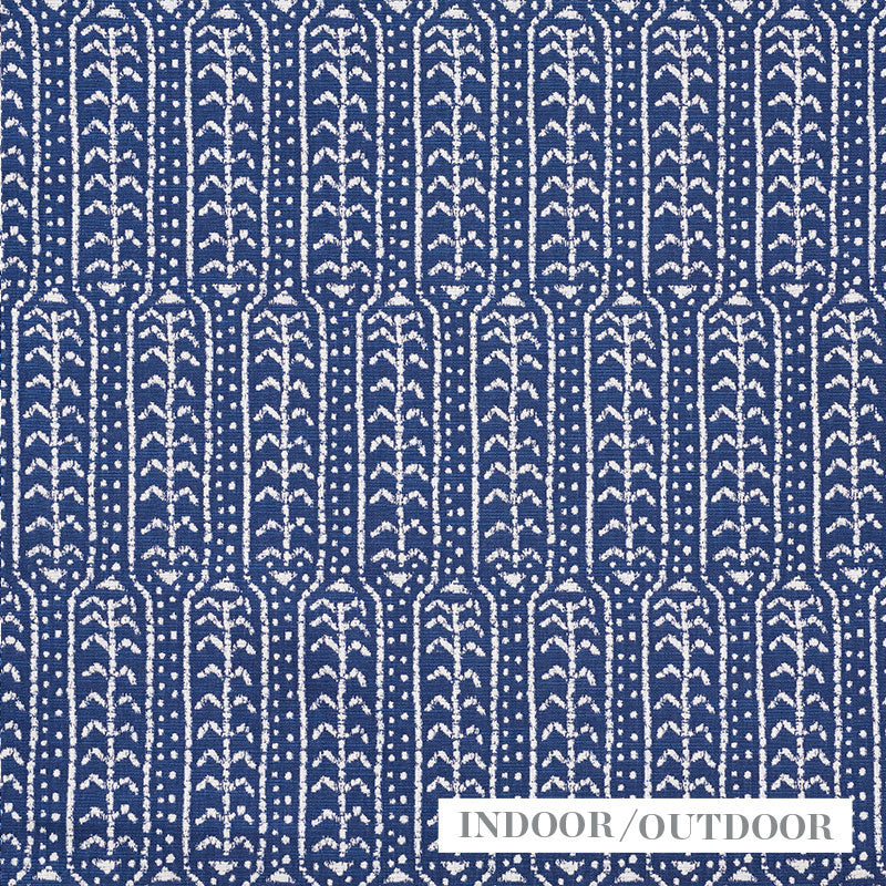 Navy blue woven textile with white vertical leaf motifs; indoor/outdoor rug.